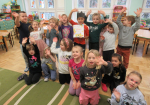 Świętujemy urodziny chłopca, dzieci stoją wokół chłopca, który ma na głowie koronę.