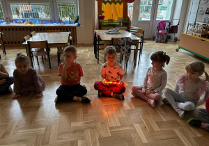 Chopiec trzyma świecącą laskę świąteczną