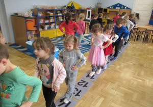 Dzieci przechodzą po ścieżce liczbowej.