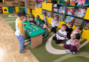 Chłopiec przelicza pojemniki z ziarenkami