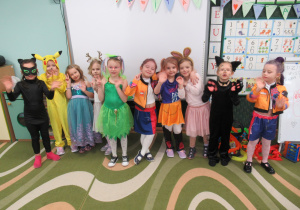 Dziewczynki pozują do zdjęcia w strojach karnawałowych.