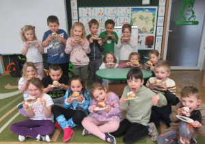 Dzieci prezentują wykonane prace z papieru - pączki.