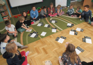 Dzieci siedzą w kole podczas zajęć matematycznych.